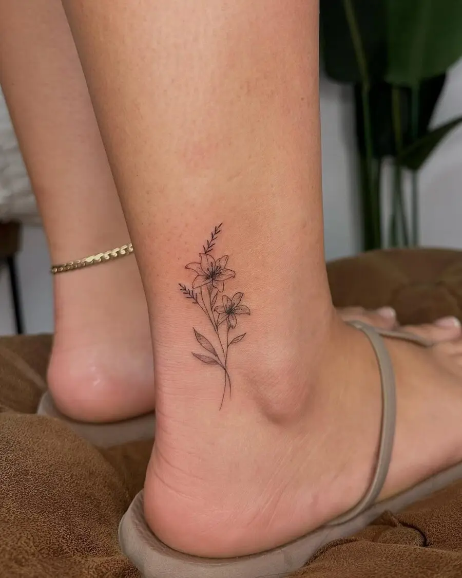 Delicate ankle tattoo with floral elements