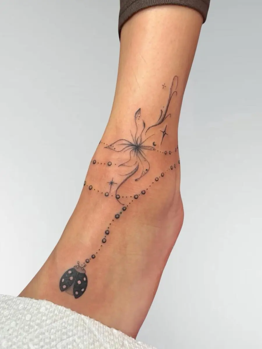 Elegant flower tattoo with whimsical accents
