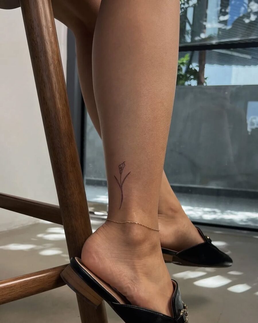 Chic minimalist flower ankle tattoo design