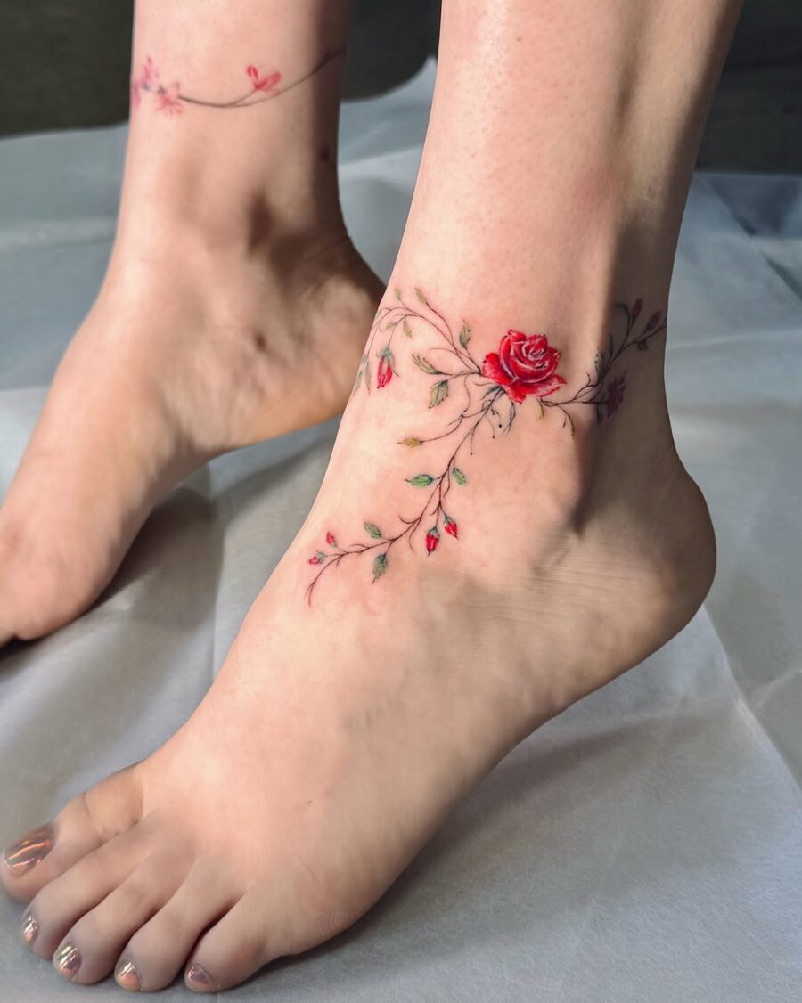 Elegant rose tattoo wraps around the ankle