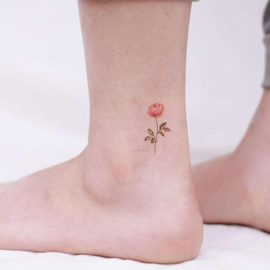 Delicate pink rose ankle tattoo in bloom
