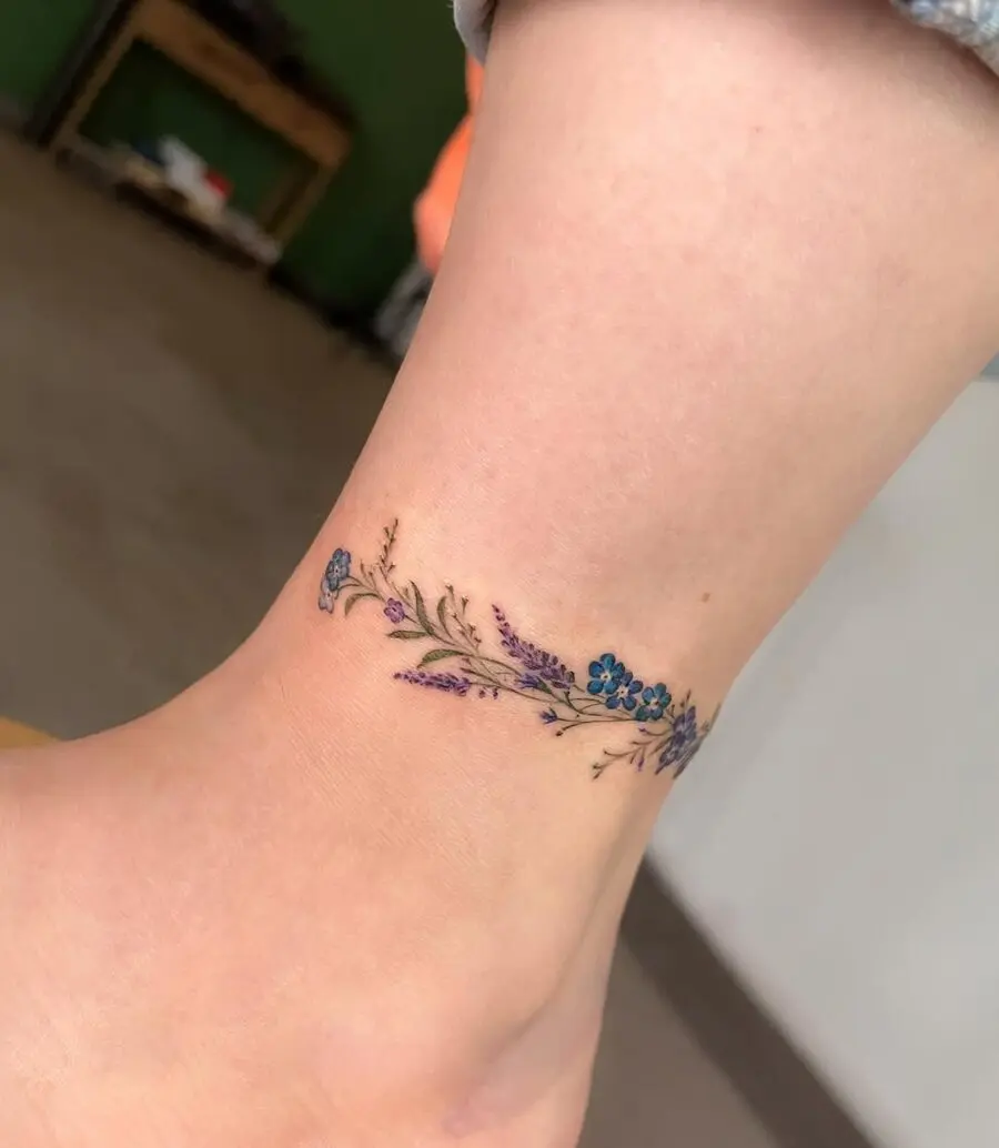 Elegant floral ankle tattoo in vibrant colors