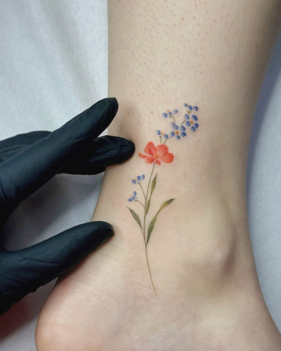 Charming floral ankle tattoo in vivid hues