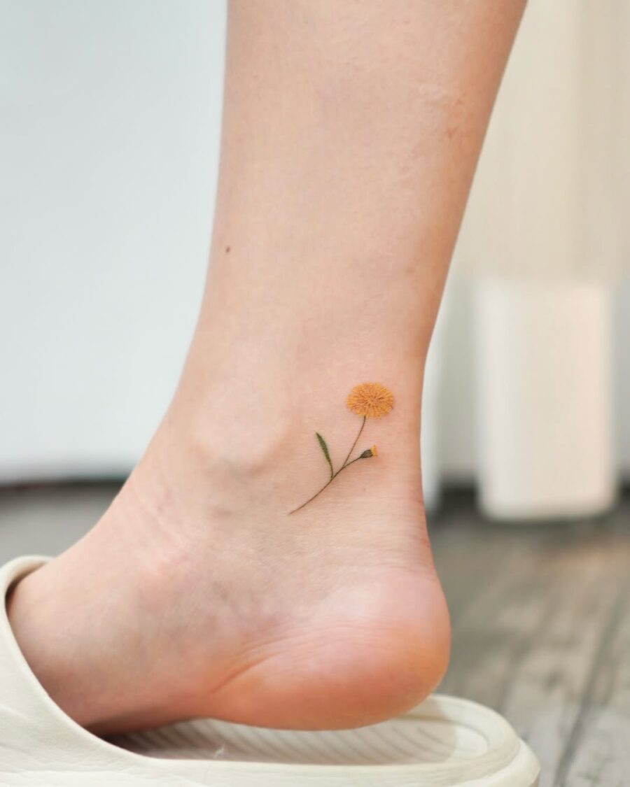 Charming yellow flower ankle tattoo for a sweet look
