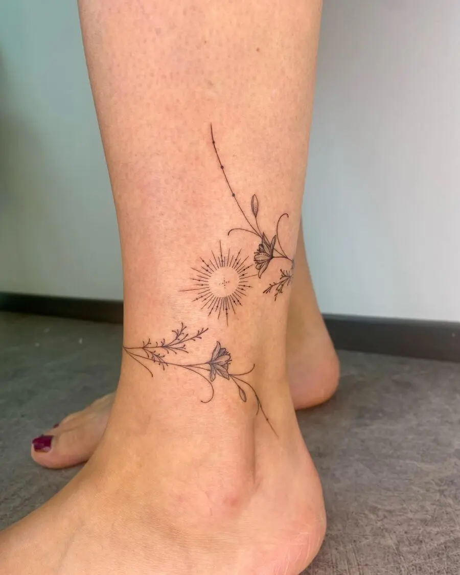 Elegant floral ankle tattoo featuring sun design