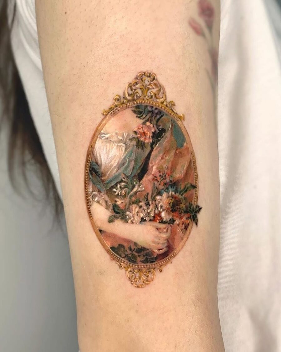Intricate floral design in ornate frame tattoo