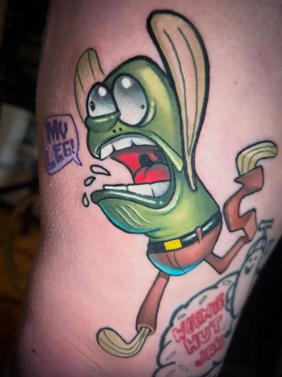 Whimsical cartoon tattoo with vibrant colors.