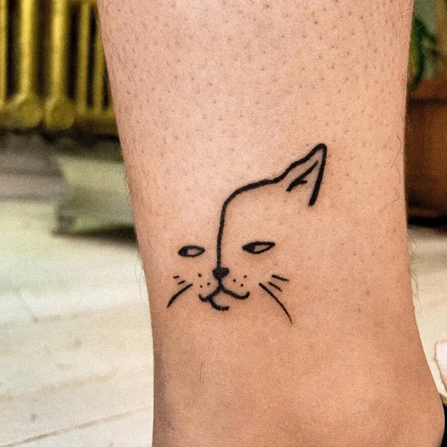 Quirky minimalist cat face tattoo idea