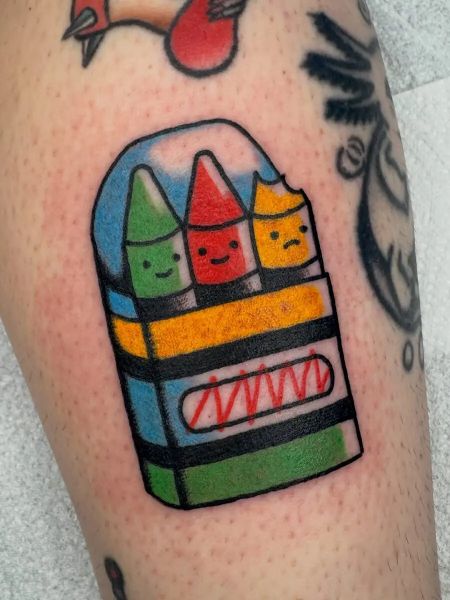 Whimsical crayon tattoo brimming with charm
