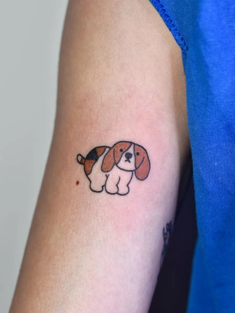 Adorable cartoon dog tattoo brings smiles