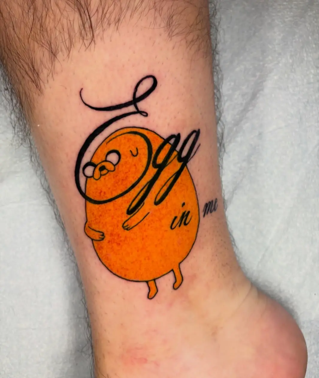 Whimsical tattoo featuring a cheerful egg character