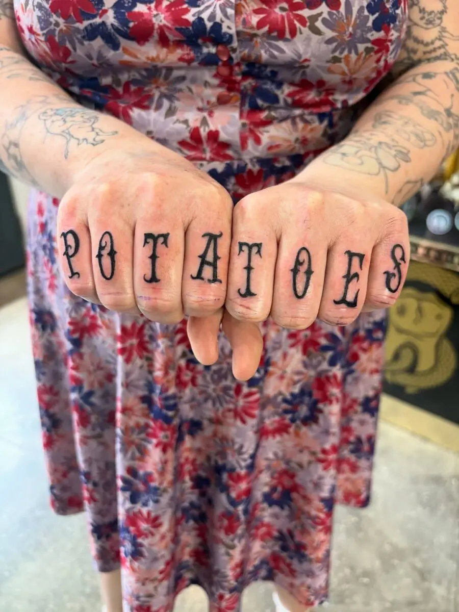 Quirky potato tattoos on fingers