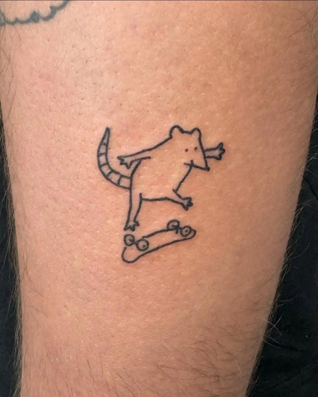 Whimsical tattoo of a skateboarding rat