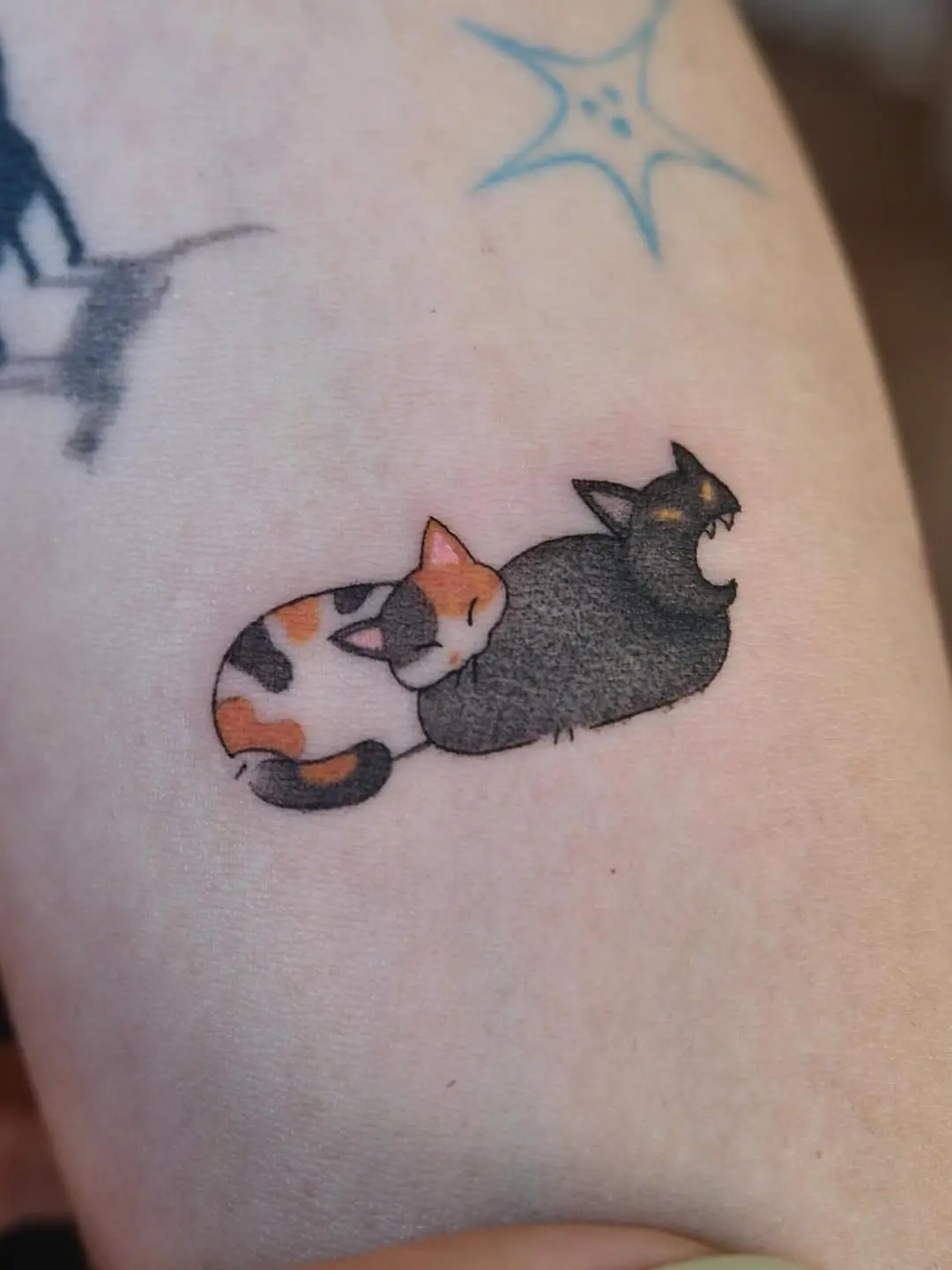 Whimsical sleeping cats tattoo design