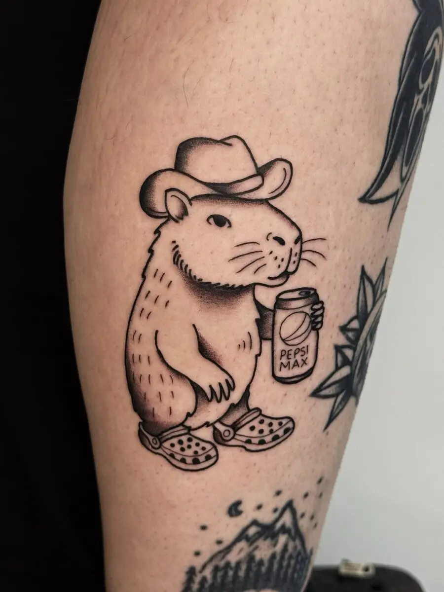 A quirky tattoo of a cowboy rat