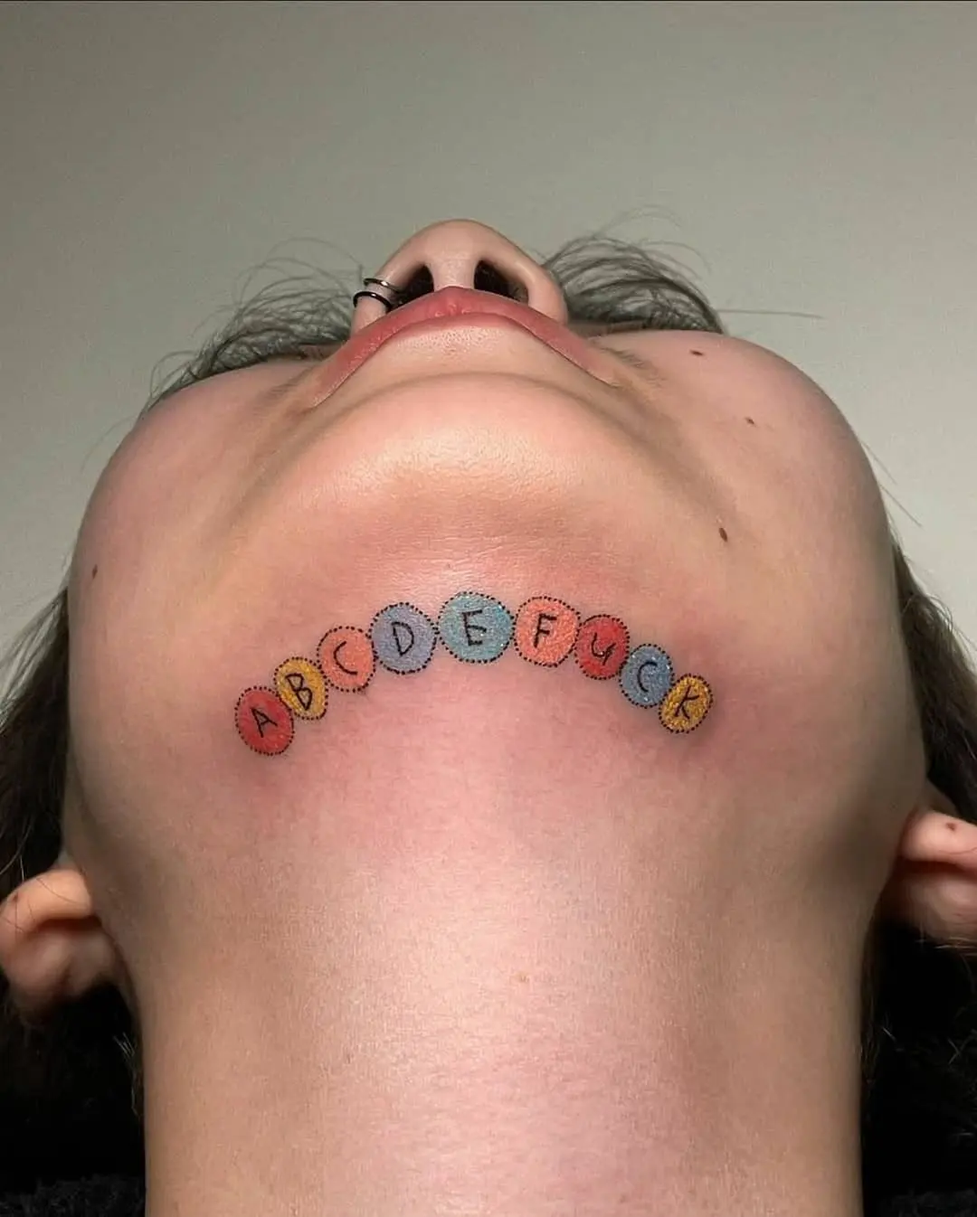 Quirky Chin Tattoo with Unexpected Message