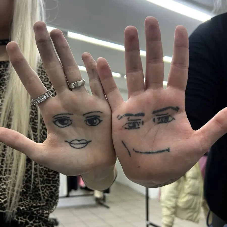 Quirky hand-drawn faces on palms