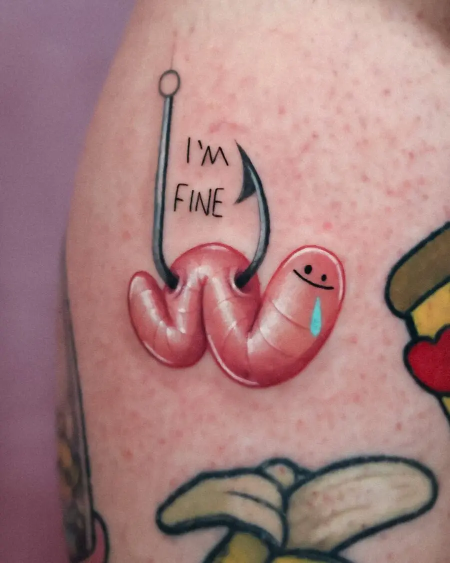Witty worm tattoo with a hook and smile