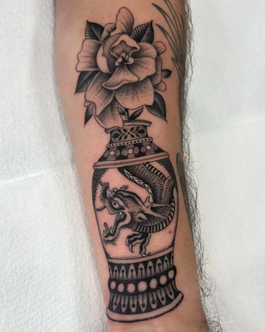 Intricate gardenia tattoo with dragon motif