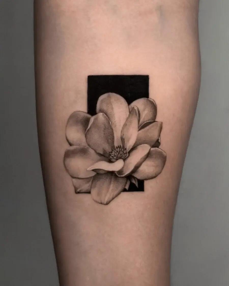 Elegant gardenia tattoo with black background contrast