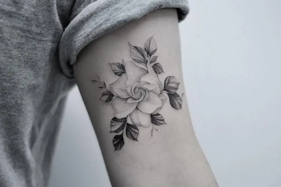 Intricately detailed gardenia arm tattoo design