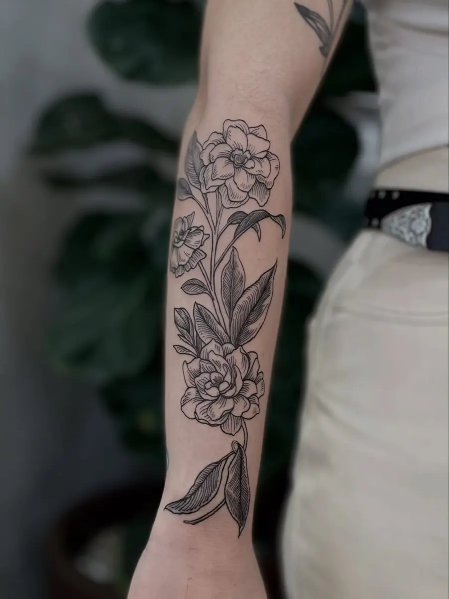 Elegant gardenia tattoo on the forearm