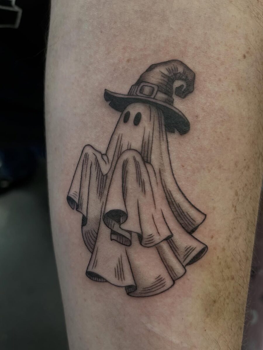 Whimsical ghost with a witch hat tattoo