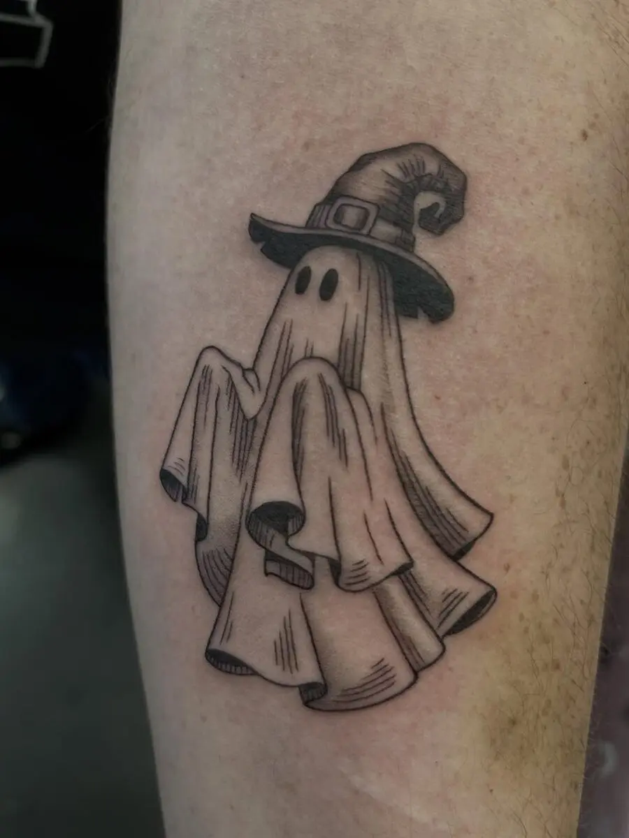 Whimsical ghost with a witch hat tattoo
