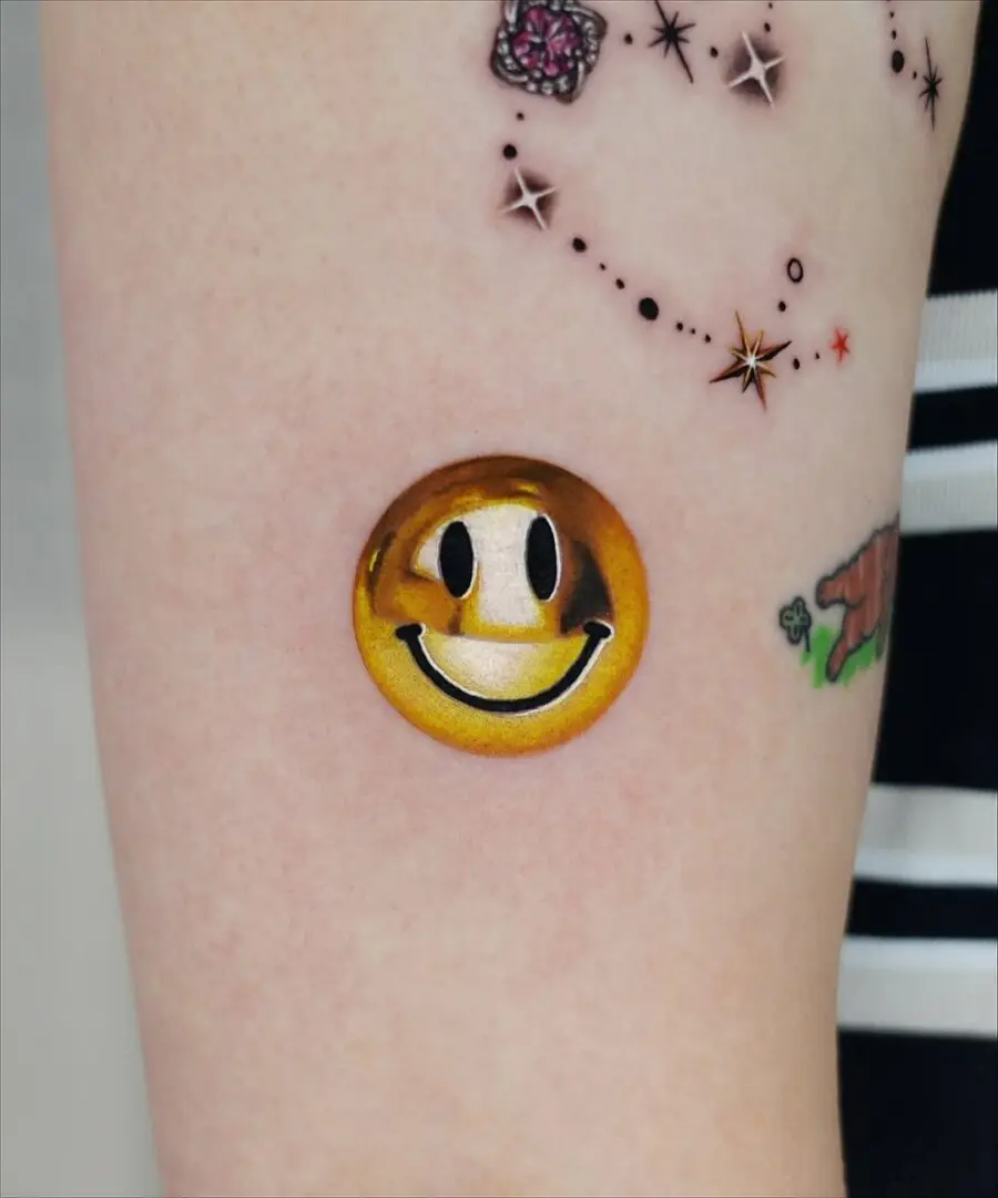 Charming golden smiley face tattoo inspiration
