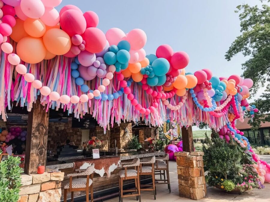 Vibrant balloon garland transforms outdoor space