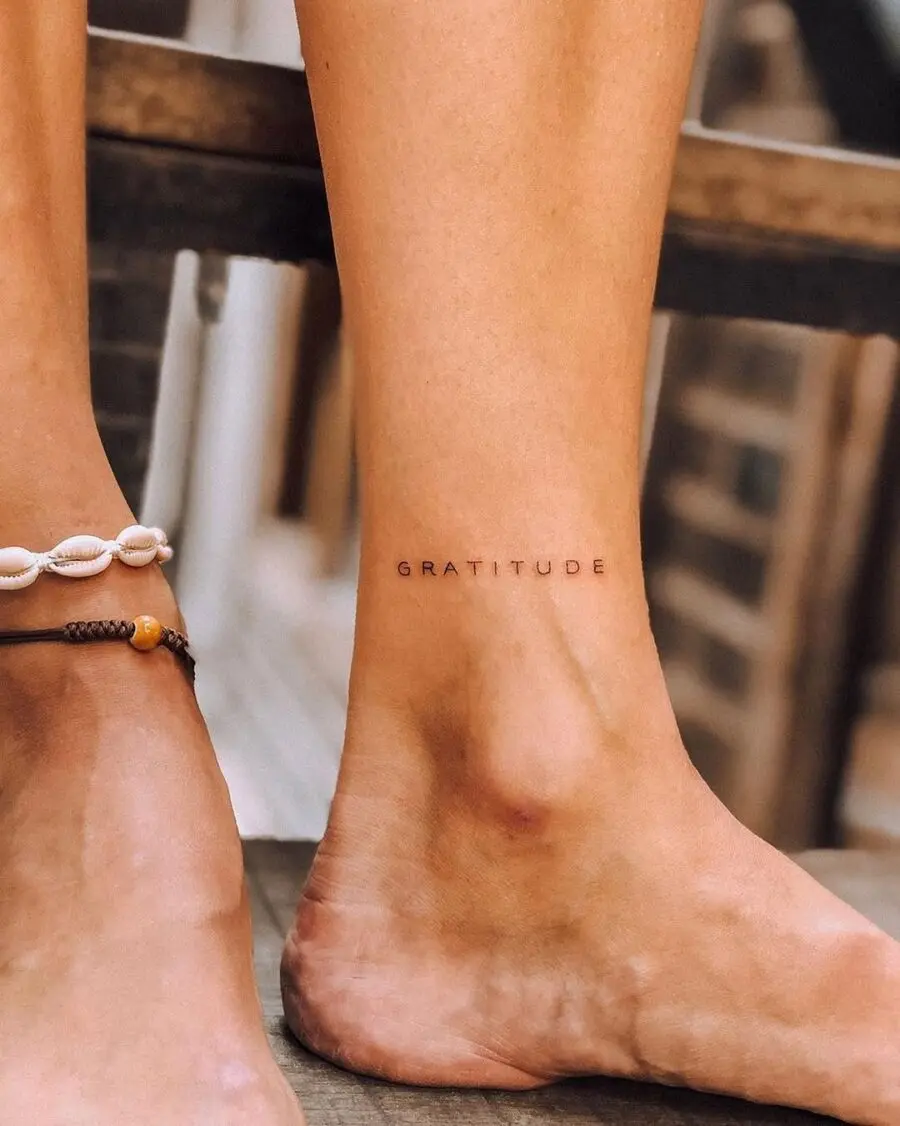 Minimalistic Gratitude Tattoo in Elegant Script