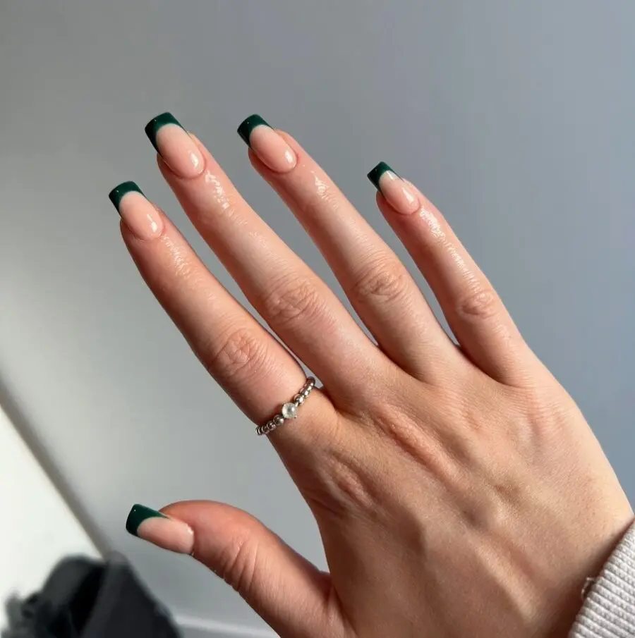 Chic green French tip nails for elegance.