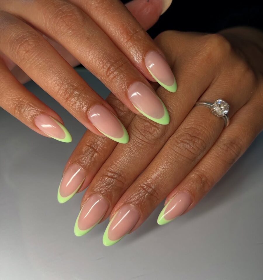 Chic green tips on elegant almond nails