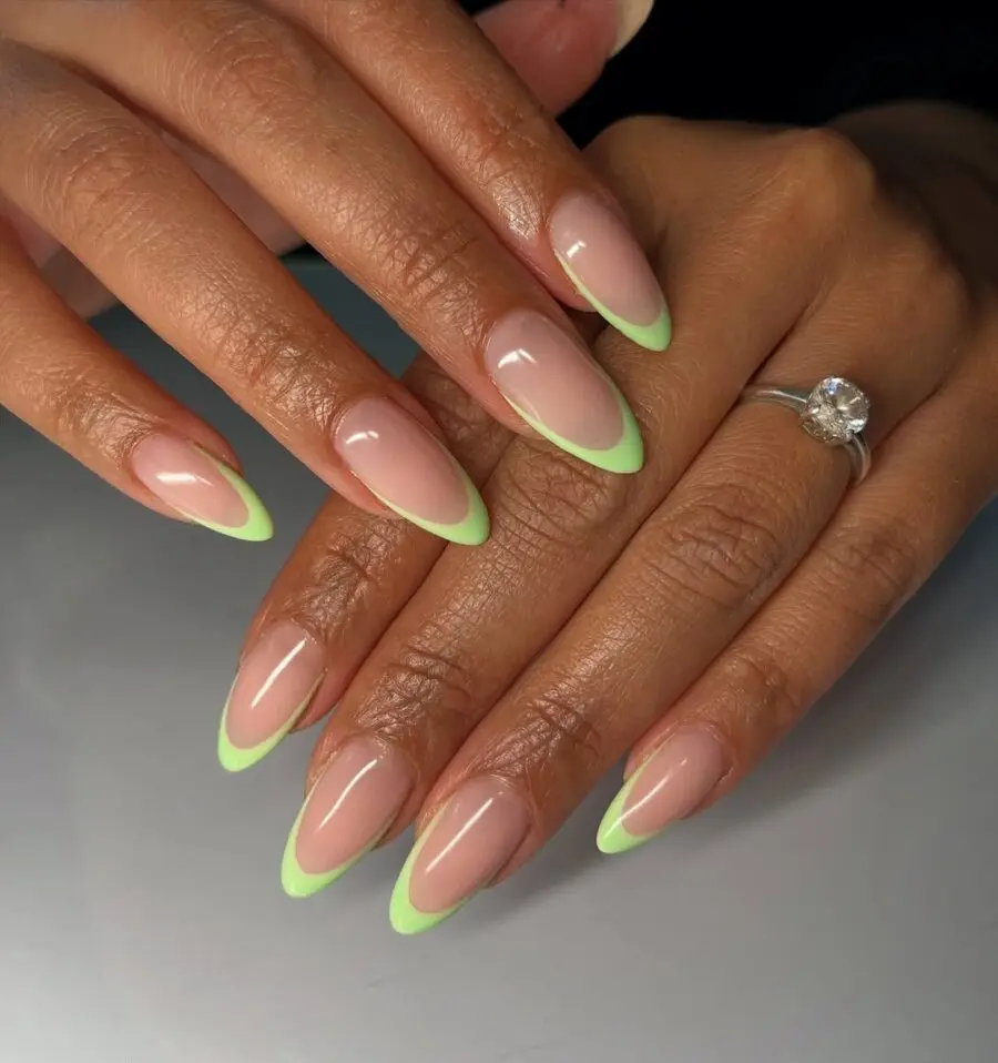 Chic green tips on elegant almond nails