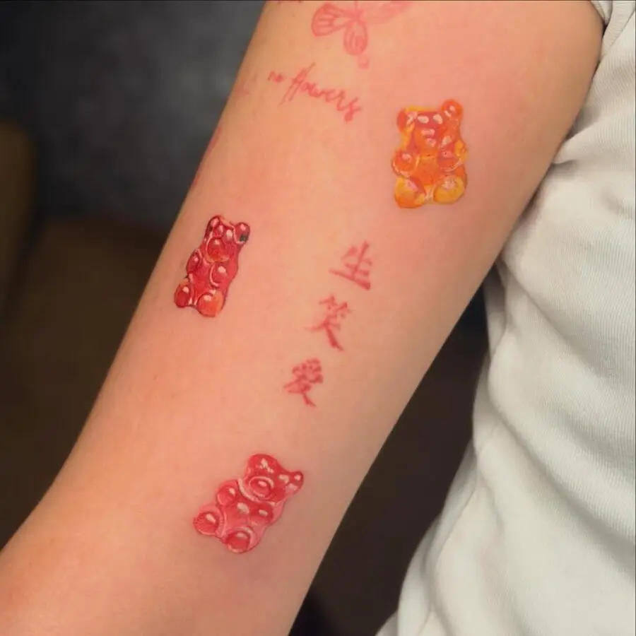 Colorful gummy bear tattoos on a playful arm