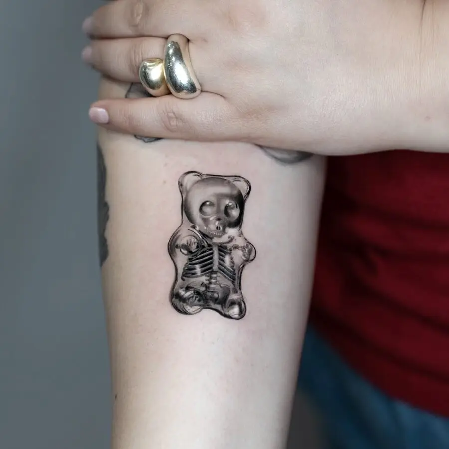 Unique skeletal gummy bear tattoo design