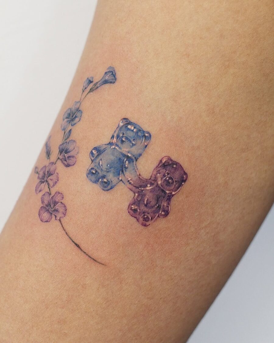 Colorful gummy bears with floral accents tattoo