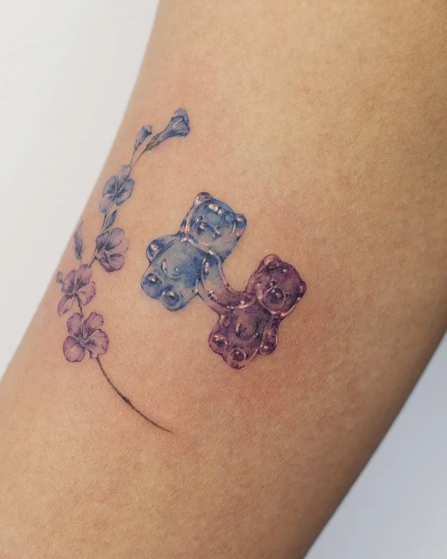 Colorful gummy bears with floral accents tattoo