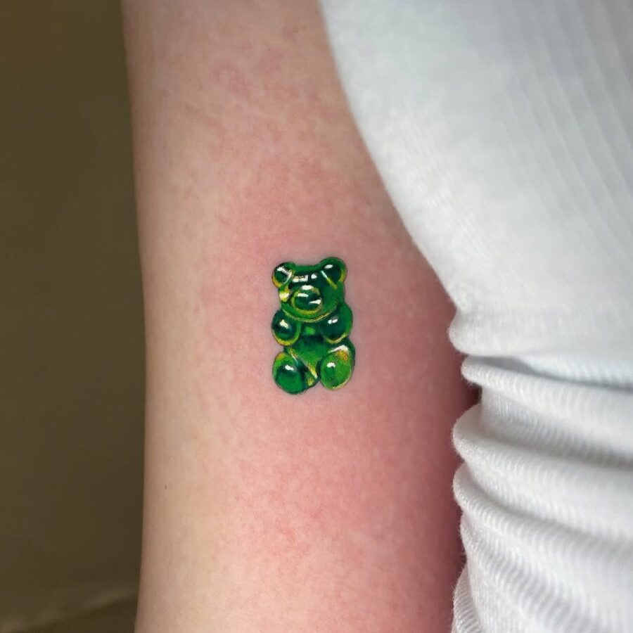Vibrant gummy bear tattoo in green hues