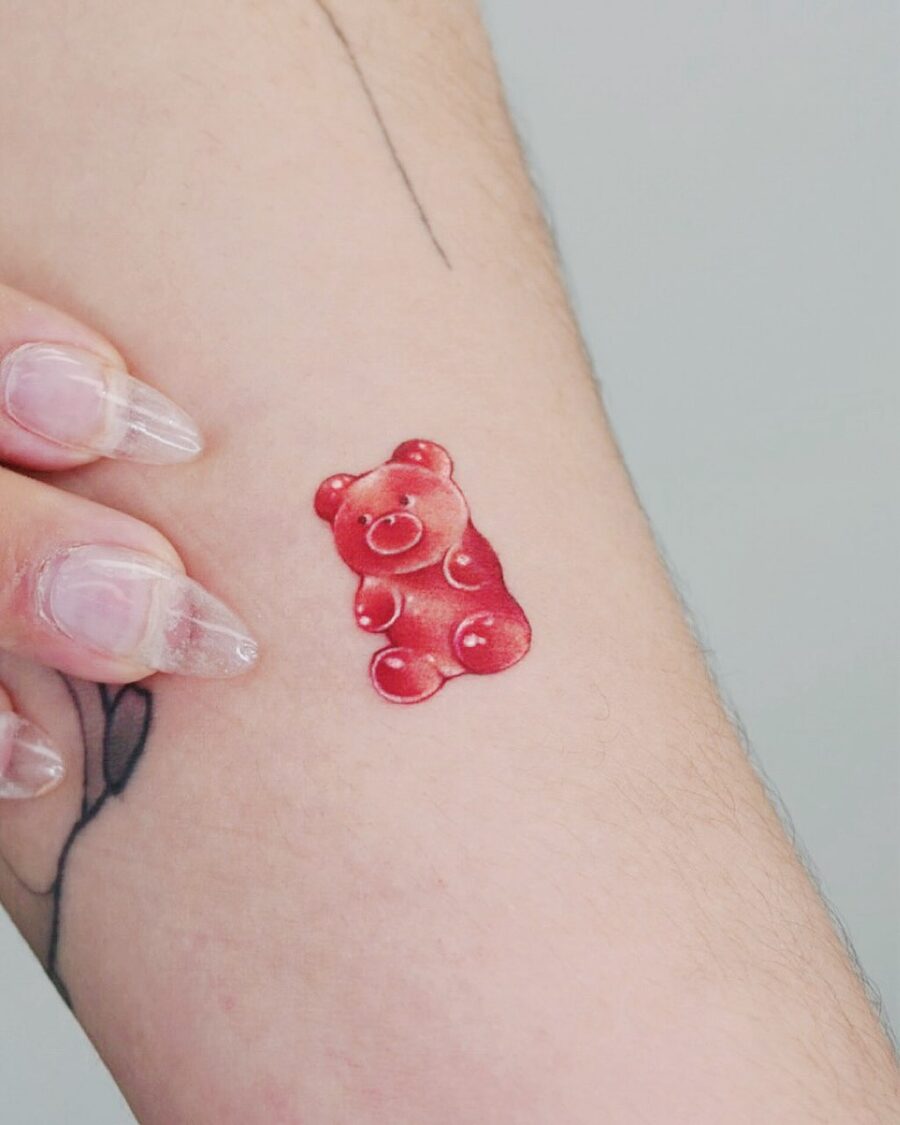 Cute gummy bear tattoo on a forearm