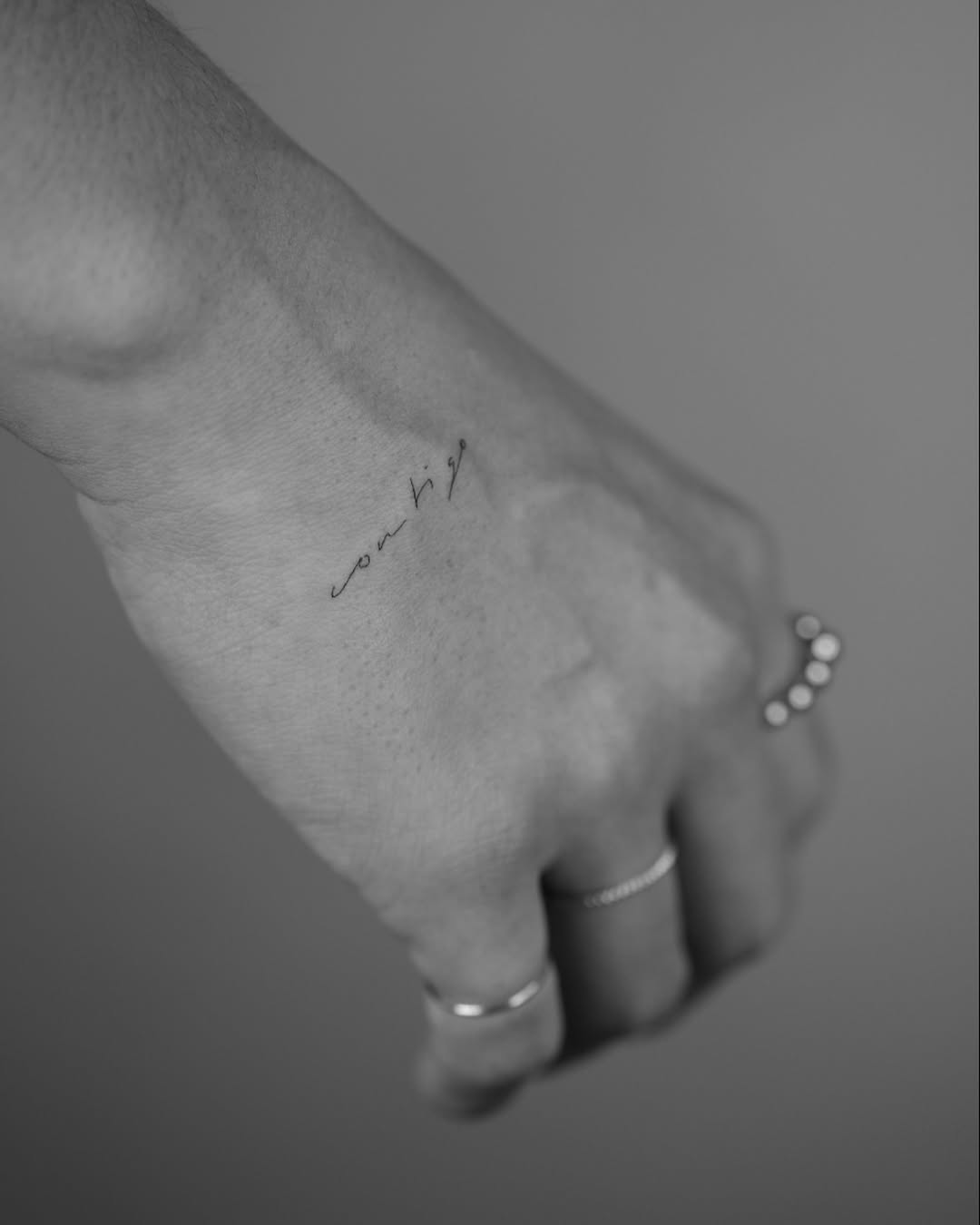Elegant handwriting tattoo on wrist area
