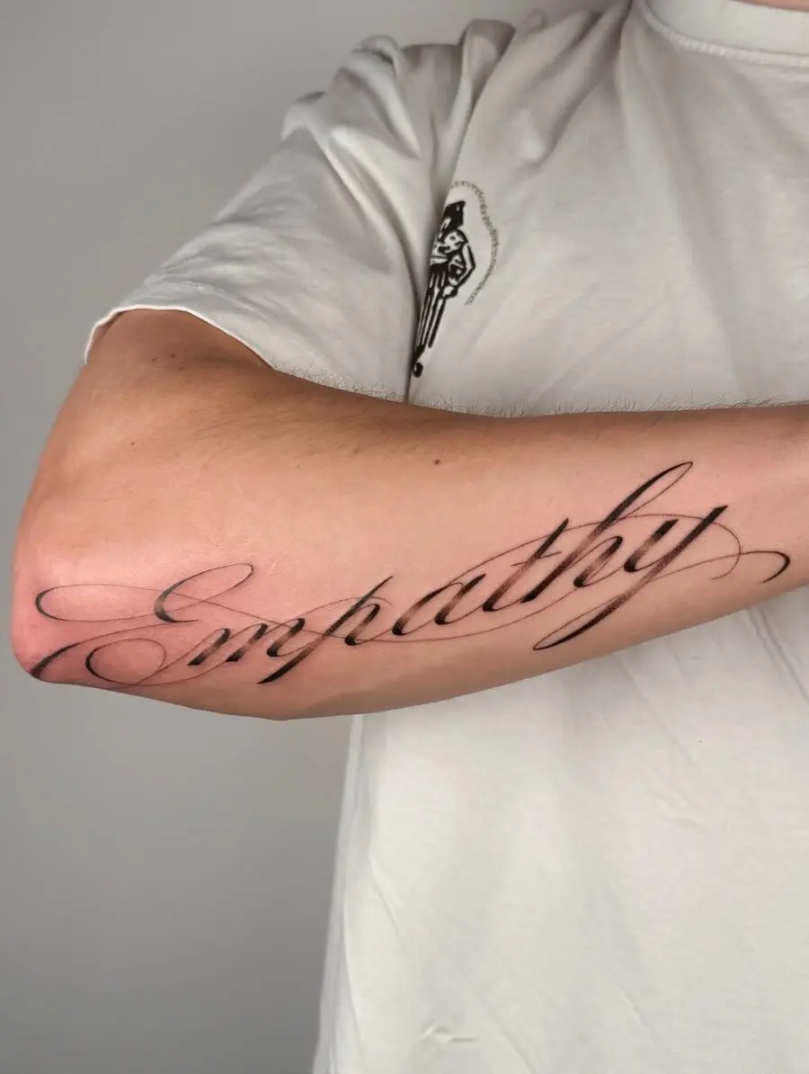 Elegant Empathy Handwriting Tattoo on Arm
