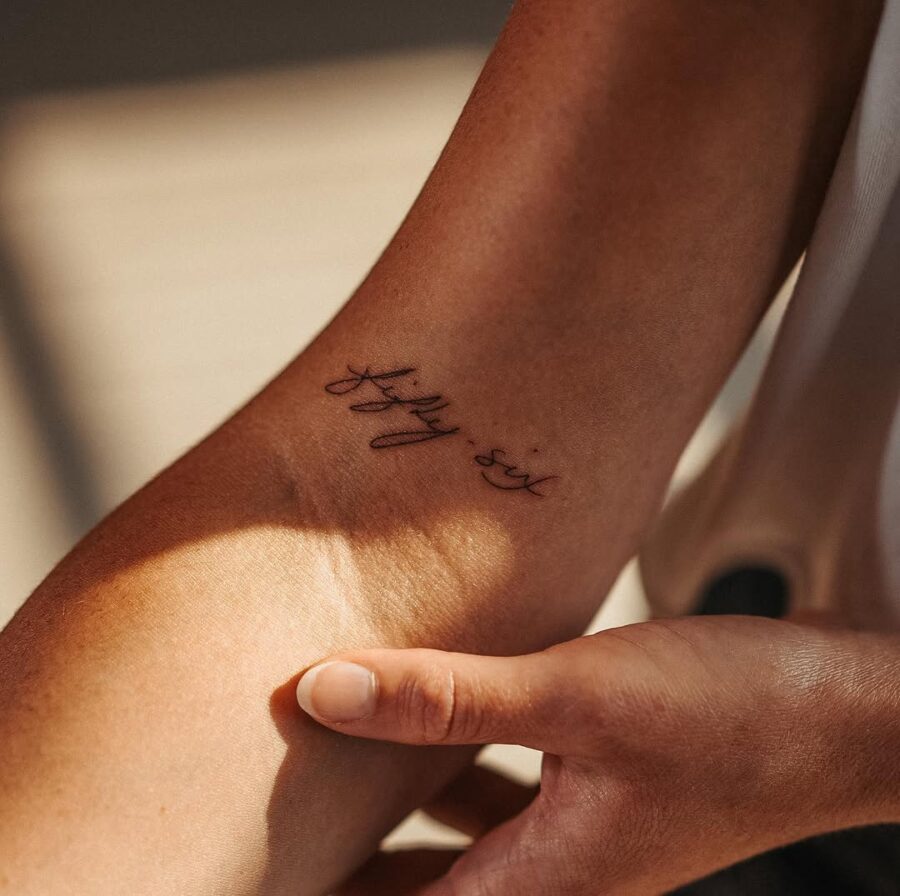 Elegant handwriting tattoo on the arm