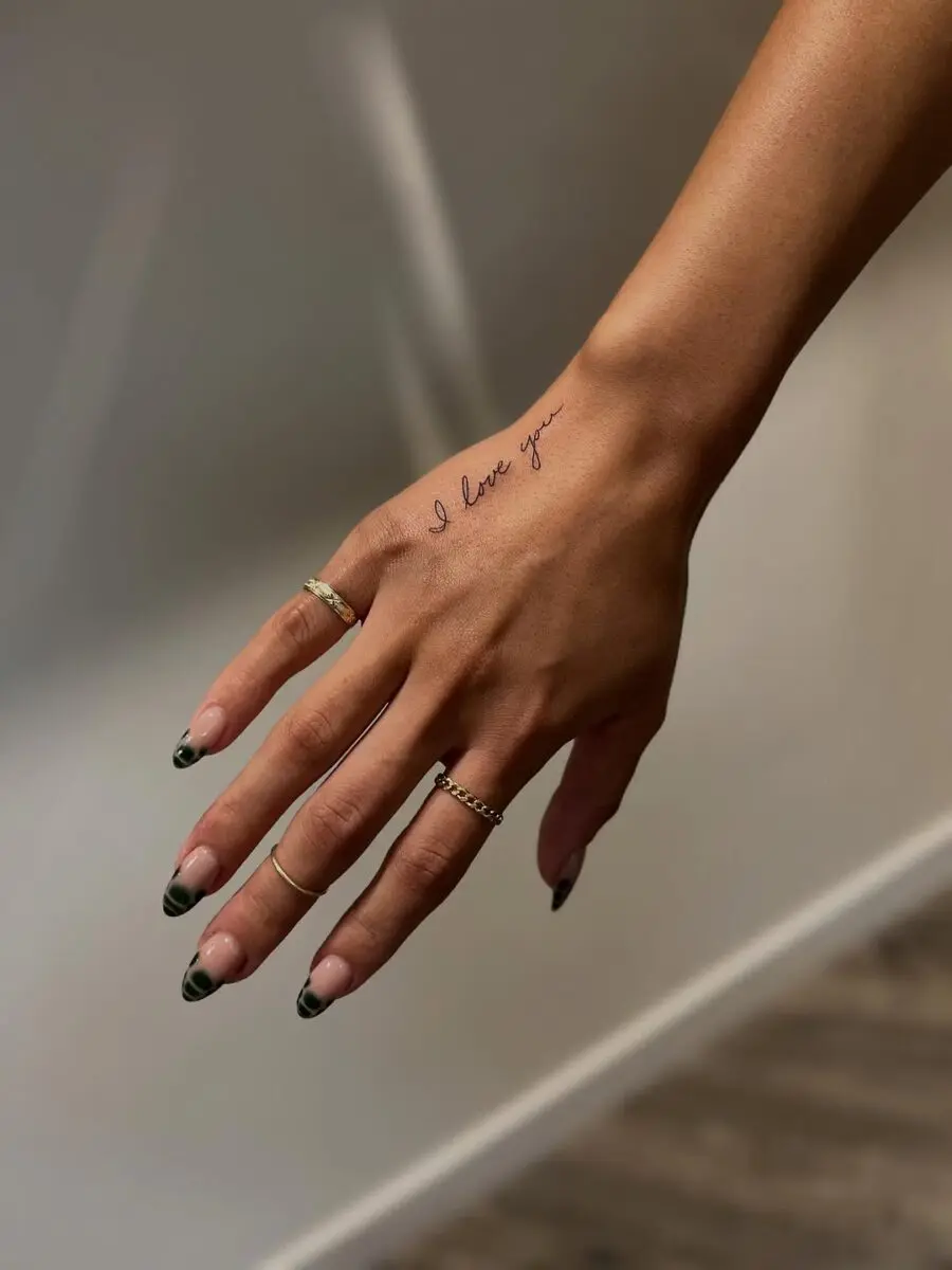 Elegant handwritten tattoo on the hand
