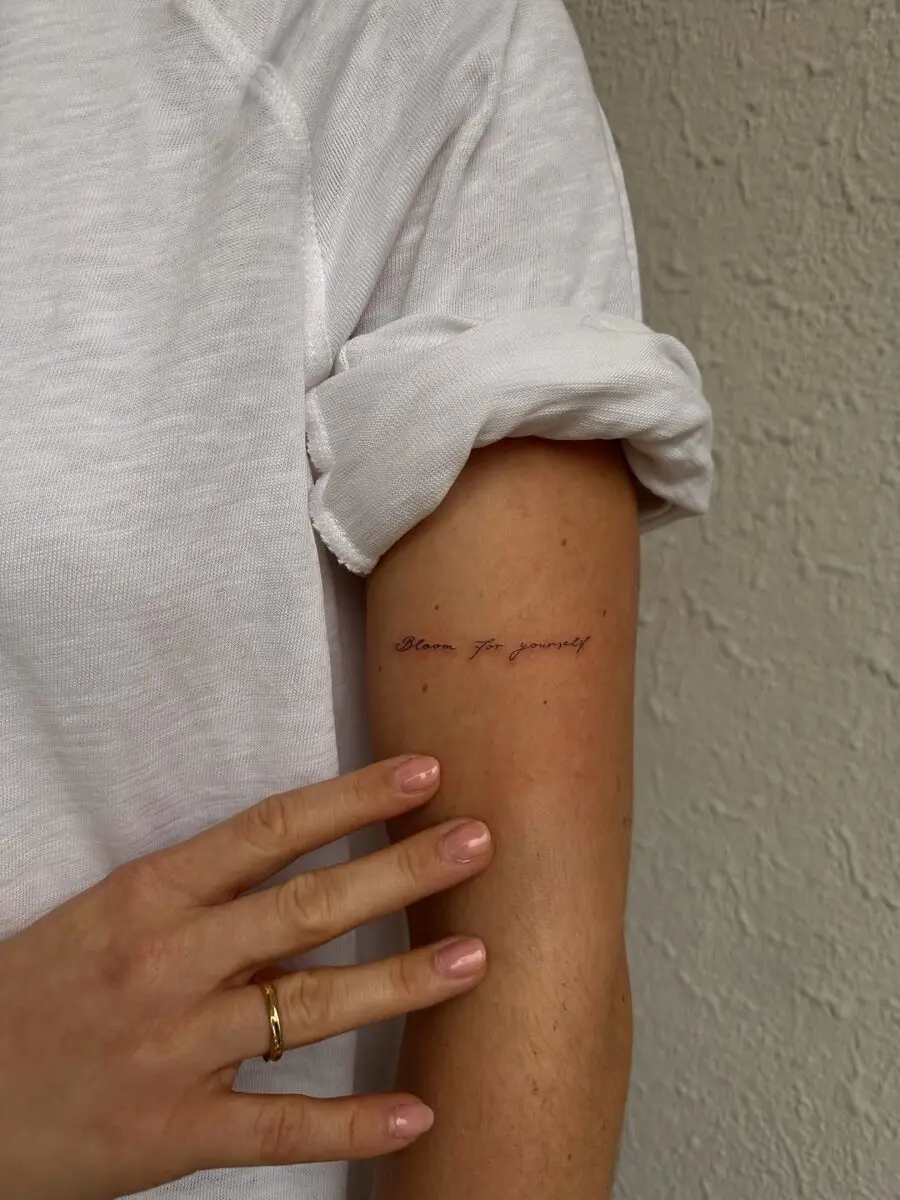 Inspirational handwriting tattoo on the arm