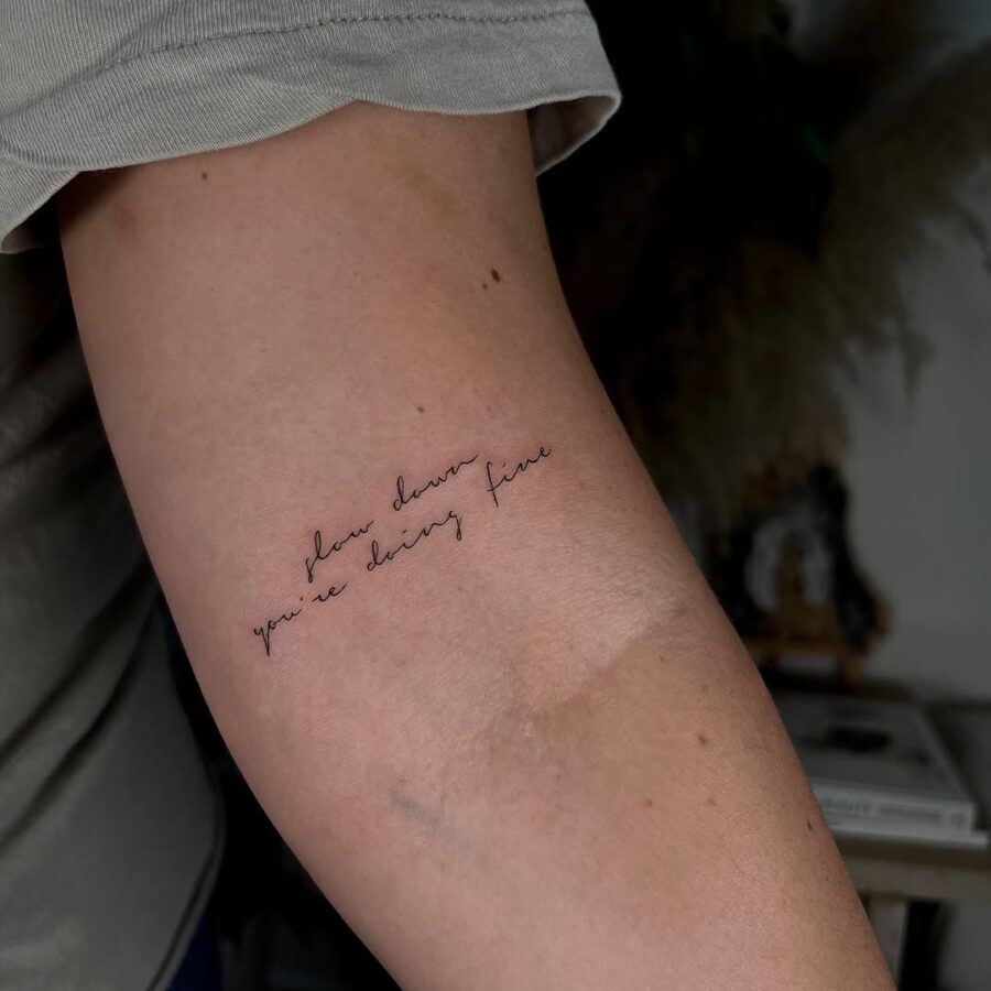 Elegant script tattoo with a motivational quote