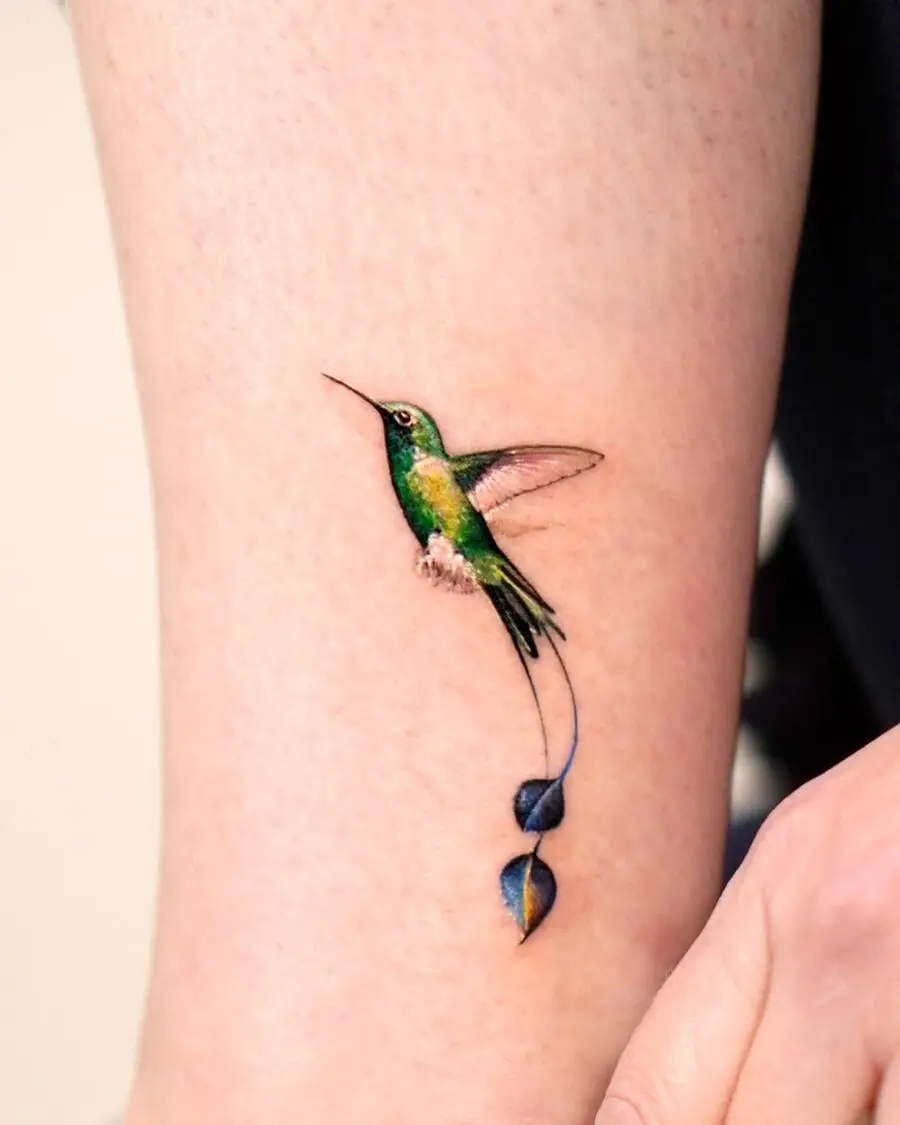 Elegant hummingbird tattoo with floral accents