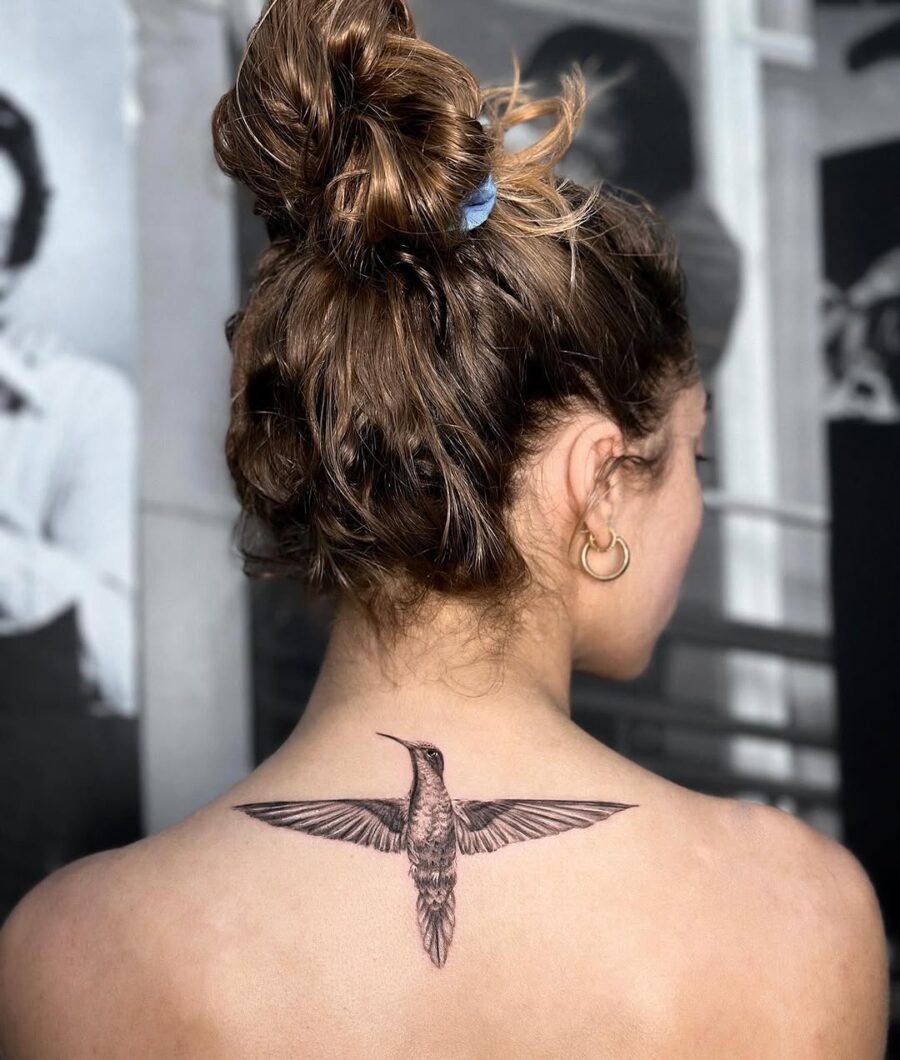 Elegant hummingbird tattoo on the back