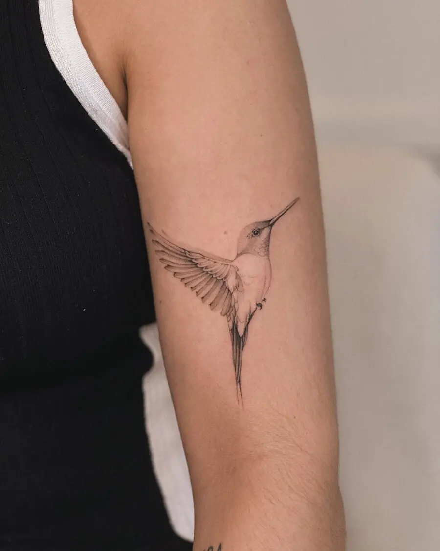 Elegant hummingbird tattoo on arm