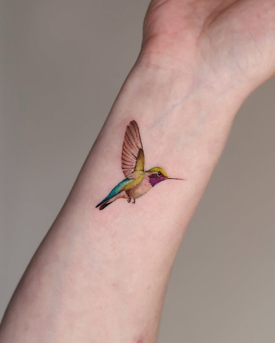 Vibrant hummingbird tattoo on the arm